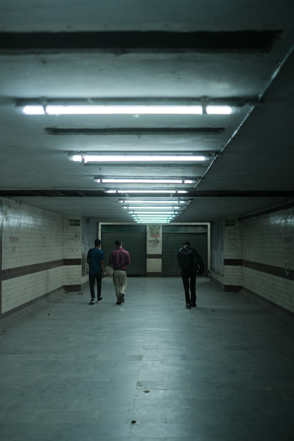 a group of people walking down a long hallway