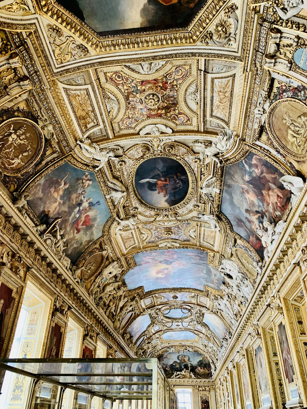 the ceiling of a building with paintings on it