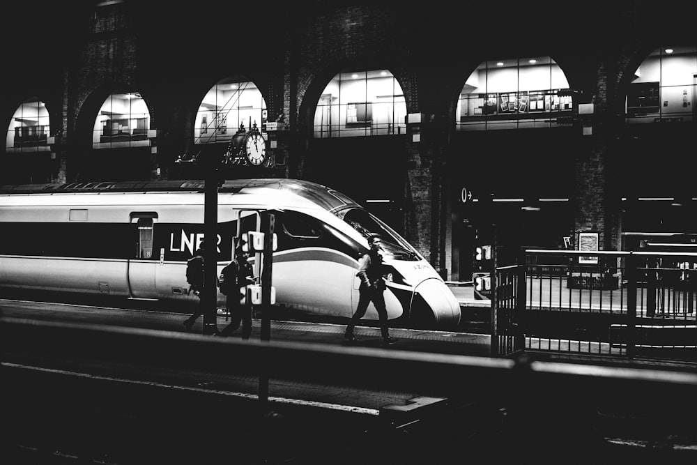 a black and white photo of a train at night