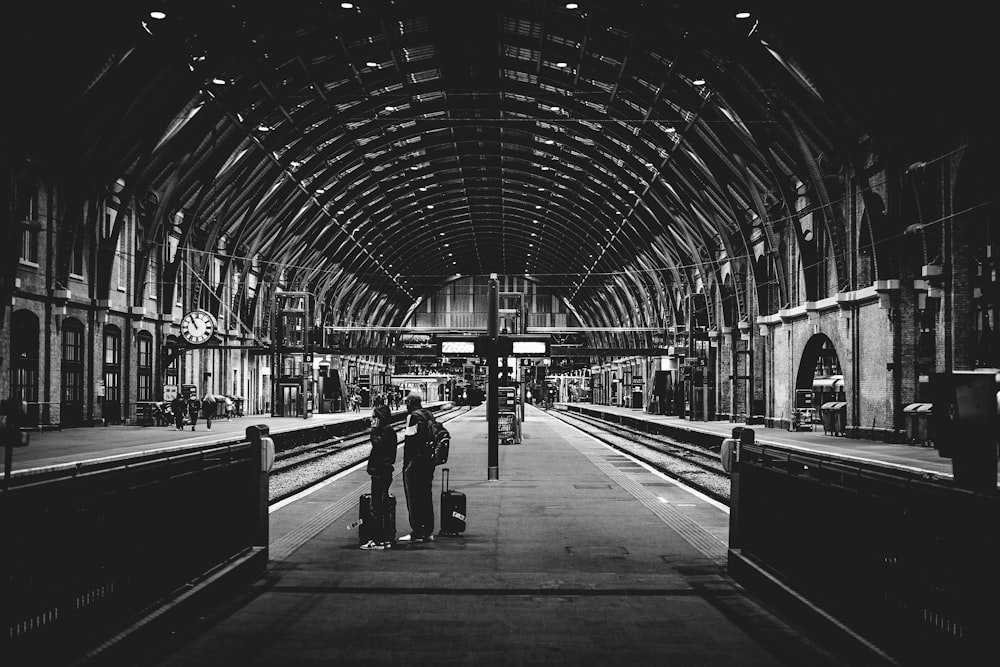 a black and white photo of a train station