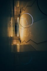 a hallway with a circular light hanging from the ceiling