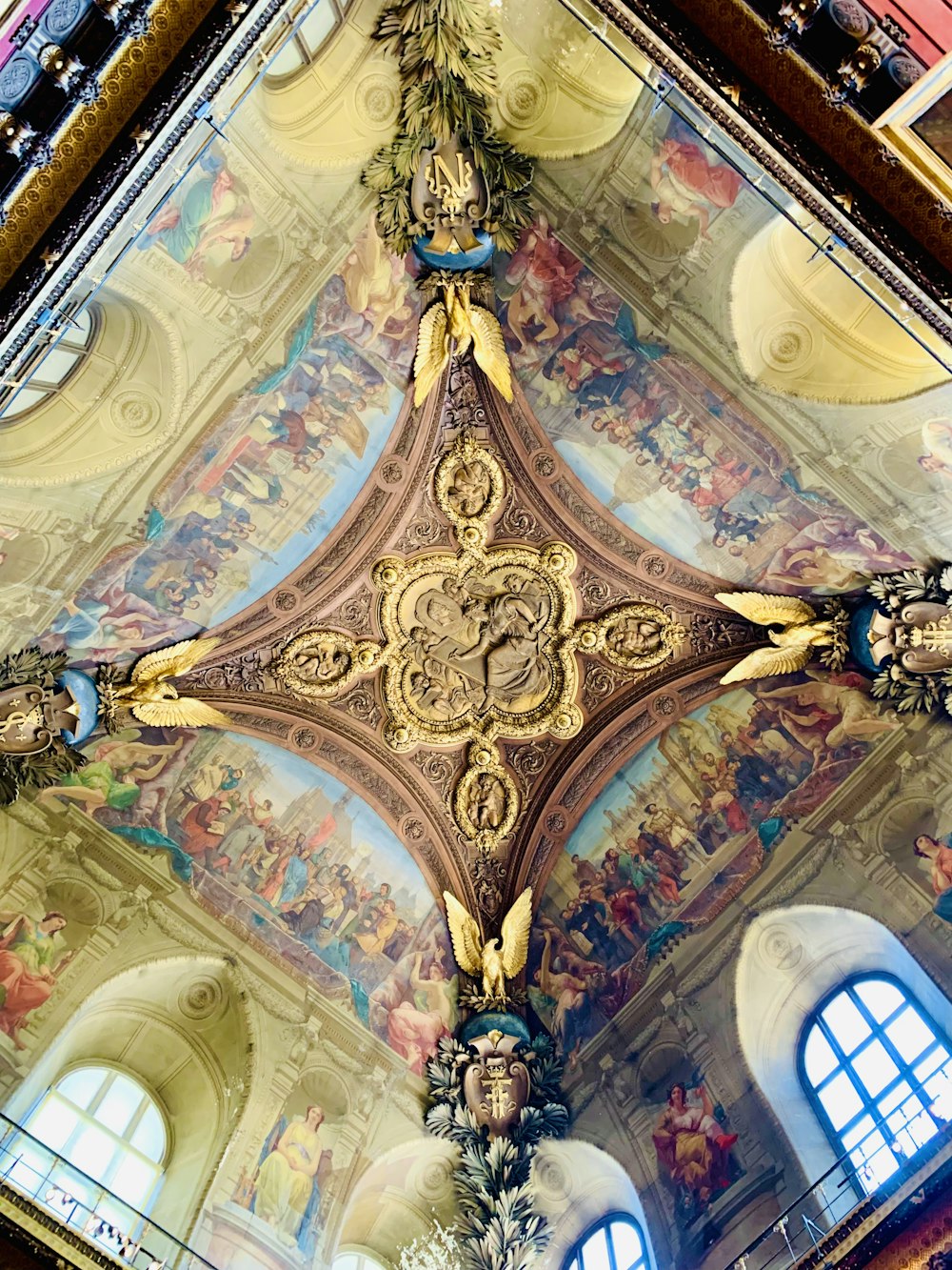 the ceiling of a church with a cross painted on it