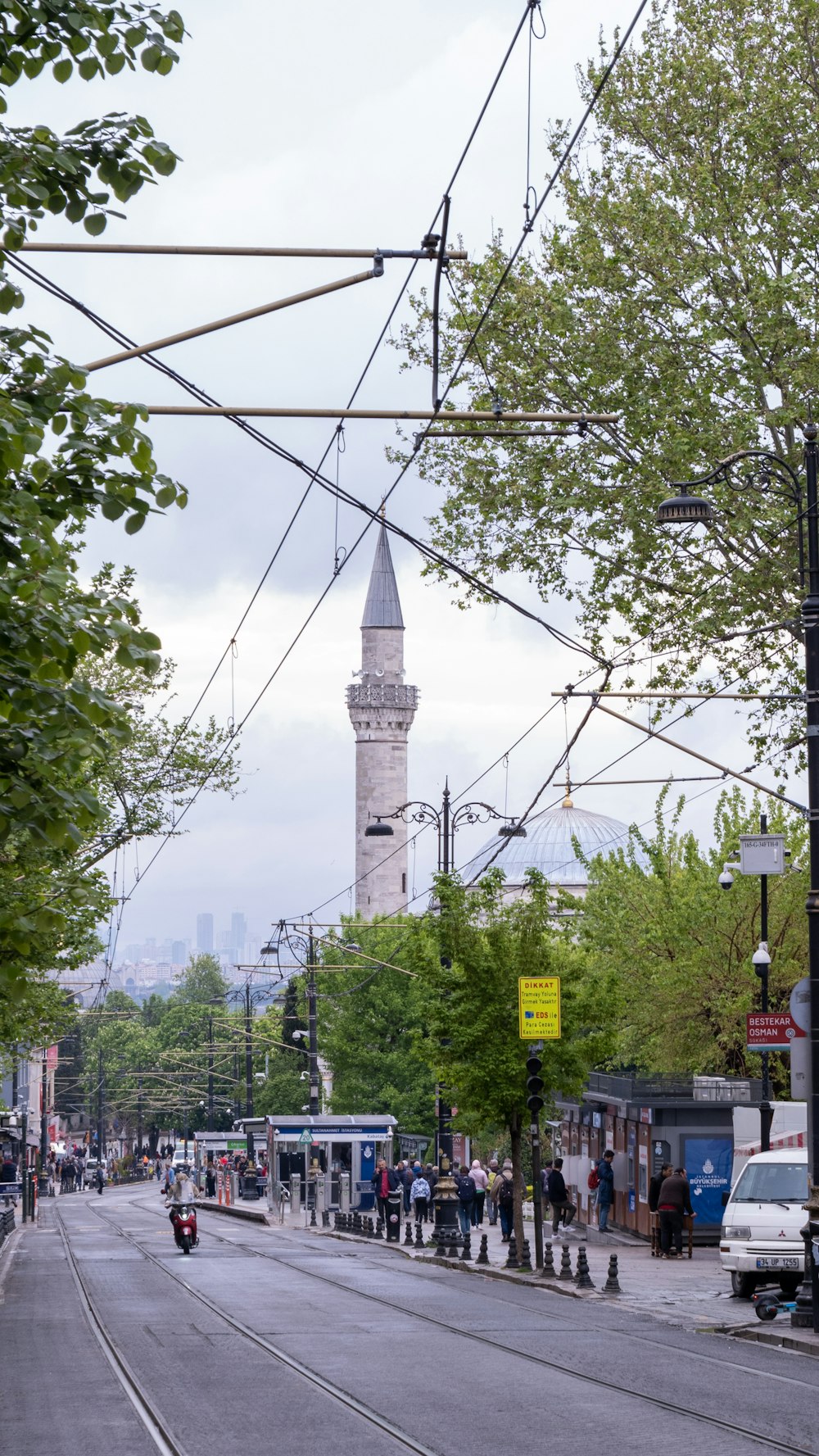 a view of a street with a clock tower in the background