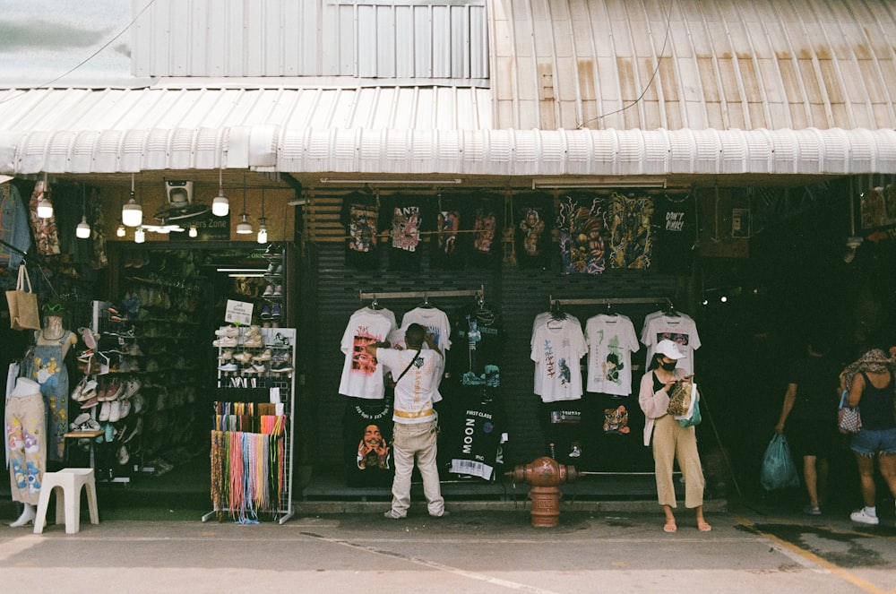 a man standing in front of a clothing store