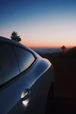 A sunset backdrop behind a sleek car, reflecting the warm lavender purple hues of monobeam horizon’s brand.