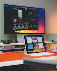 A sleek, minimalist workspace with screens showing film editing and brand designs.