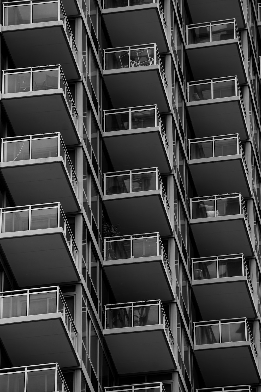 a black and white photo of a building with balconies