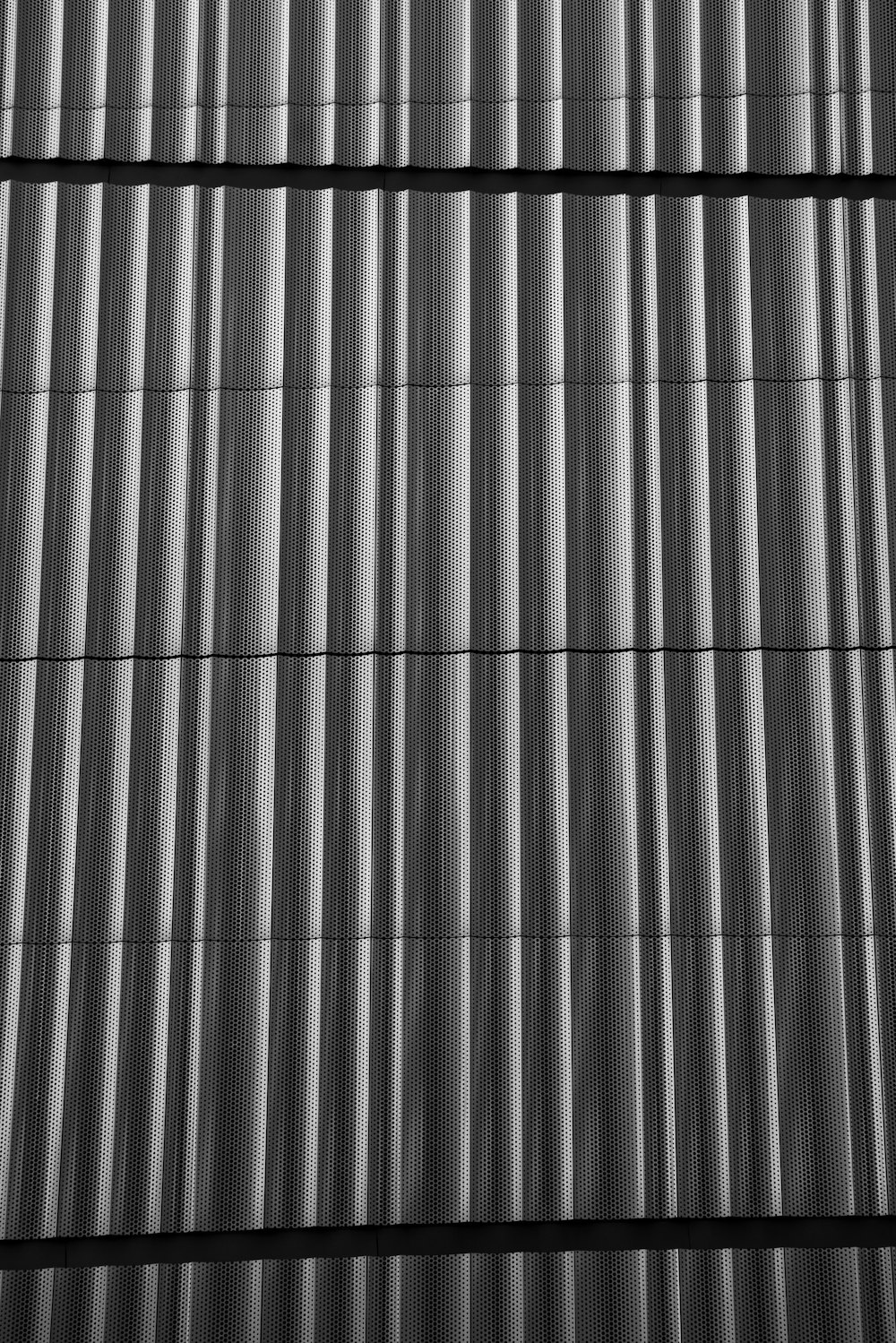 a black and white photo of a metal wall