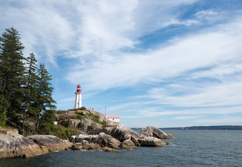 a light house sitting on top of a rocky shore