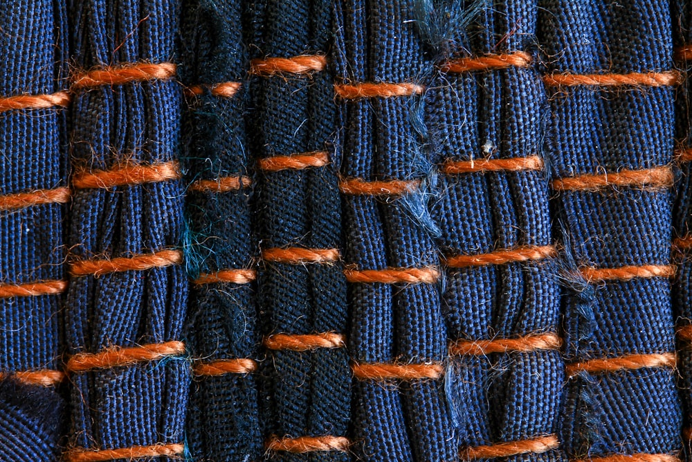 a pile of blue and orange rope with orange ends