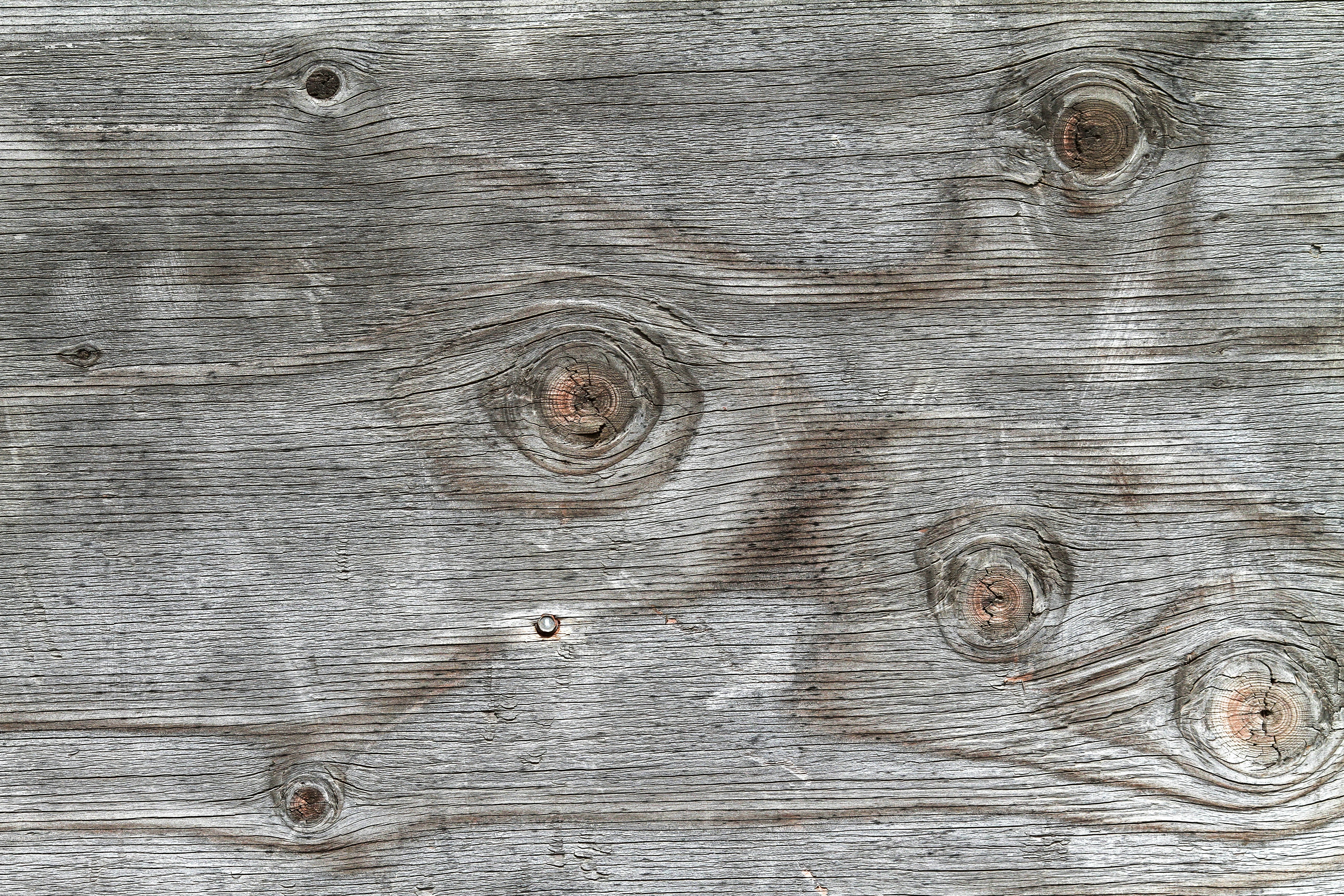 a close up of a wooden surface with holes in it