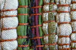 Close-up of handcrafted pet collar with vibrant patterns laid on natural fabric.
