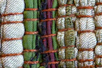 Close-up of handcrafted pet collar with vibrant patterns laid on natural fabric.