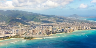 an aerial view of a city and the ocean