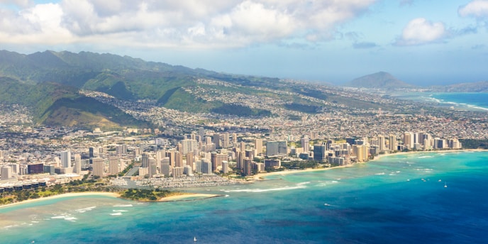 an aerial view of a city and the ocean