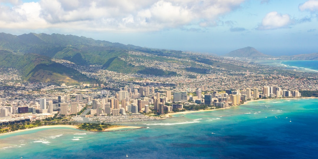 an aerial view of a city and the ocean,