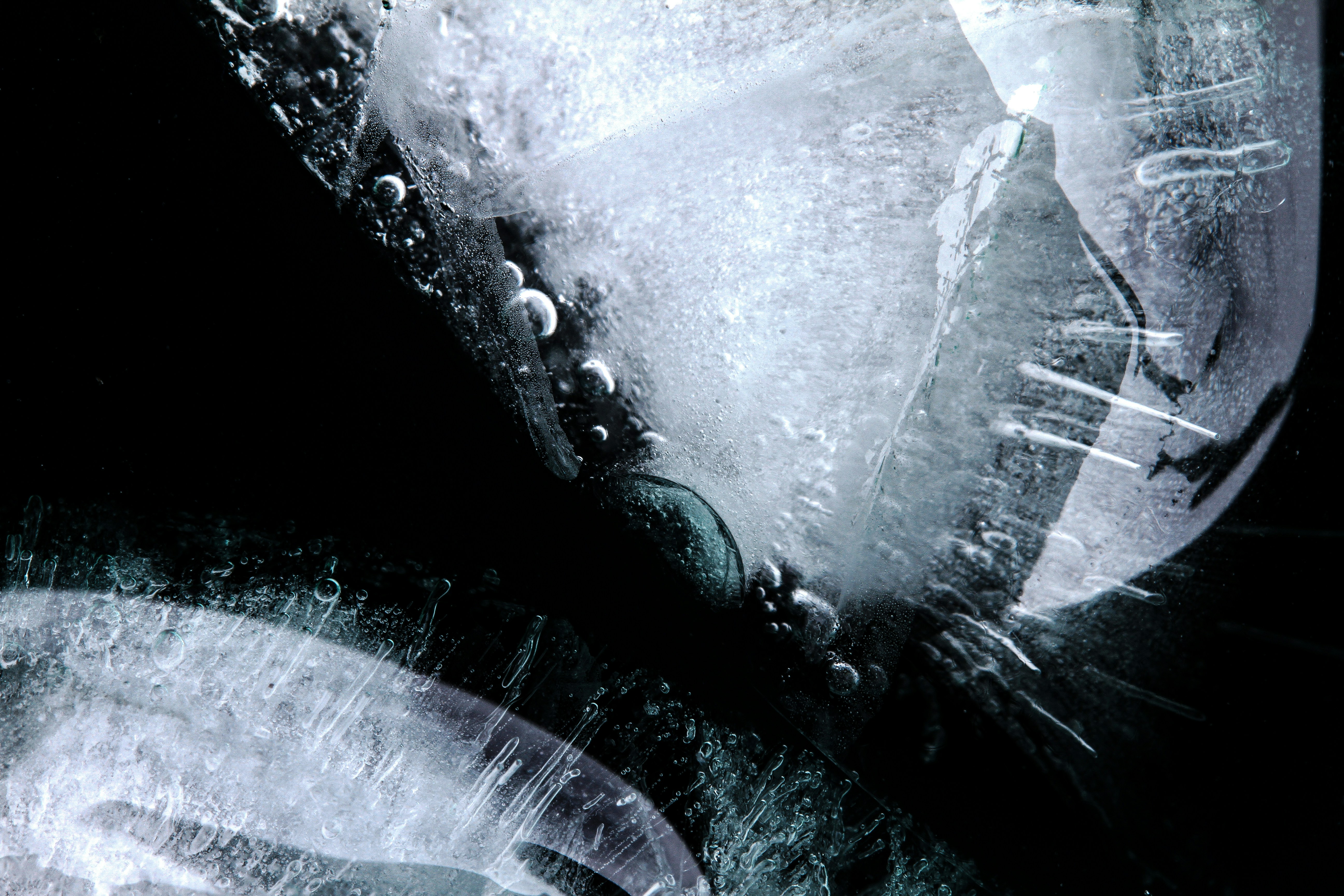 Macro shots of ice floating in water.