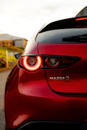 Close-up artistic shot of Mazda3’s front grille with soft natural lighting