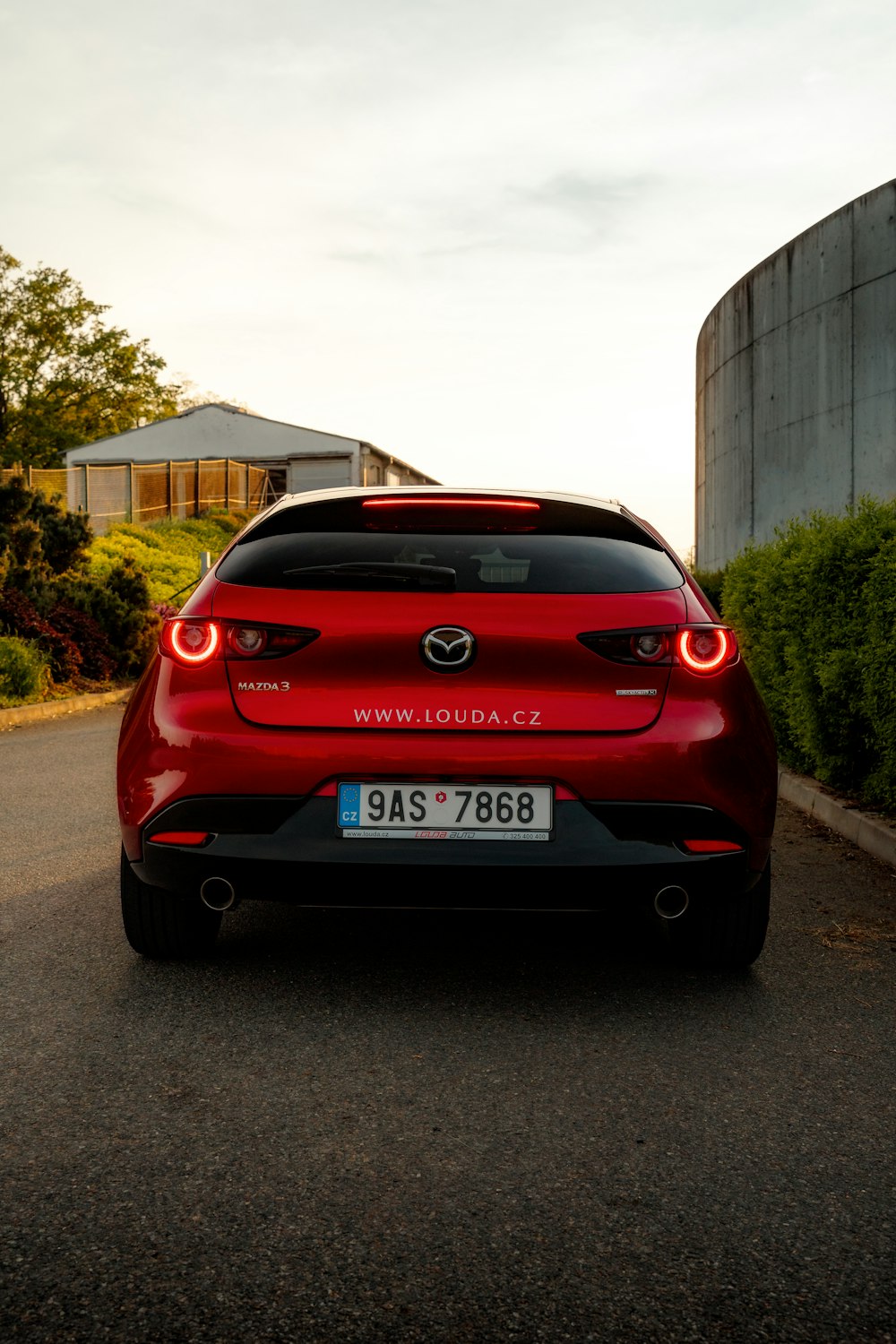 a red car parked on the side of a road