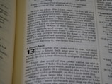 The image captures a page from an open book, likely a Bible, featuring prominently highlighted text in bold and large font, indicating chapter 13, titled 'A linen belt'. The surrounding text includes paragraphs of scripture in smaller font with several verses.