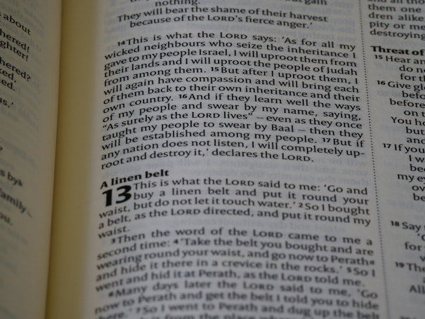 A snapshot from the Christian broadcasting TV show showing Thom reading a worn Bible in prison.