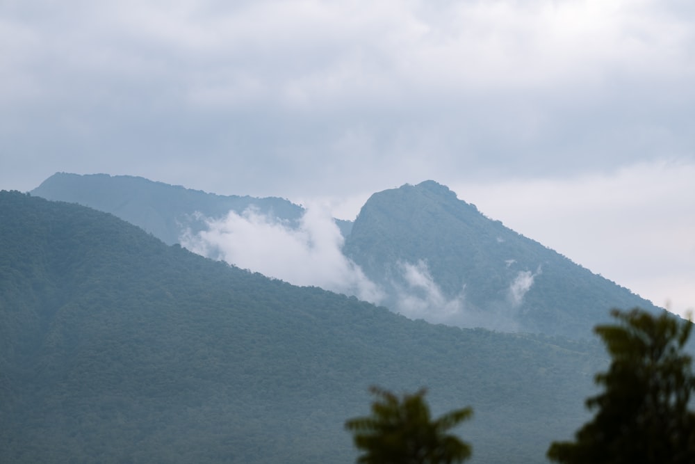 a view of a mountain range with low clouds