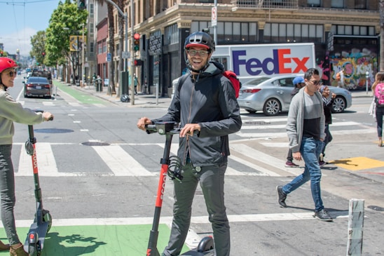 A vibrant illustration showing diverse riders, drivers, and delivery partners interacting happily within a bustling cityscape.