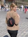 a woman walking down a street with a backpack on her back
