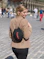a woman walking down a street with a backpack on her back