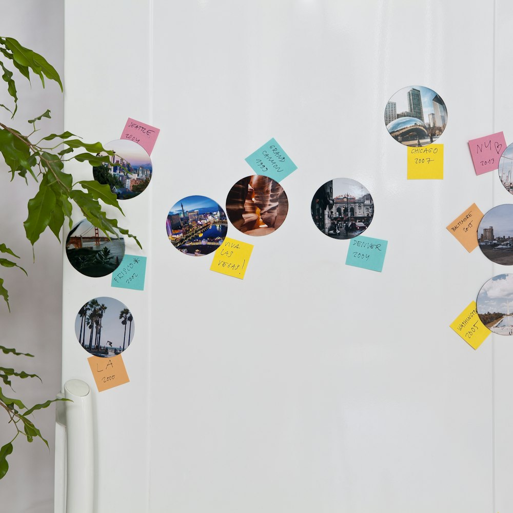 a white wall with a bunch of post it notes attached to it