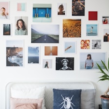 A large, inviting photo gallery wall displaying vibrant images of the house’s bedrooms and bathrooms.