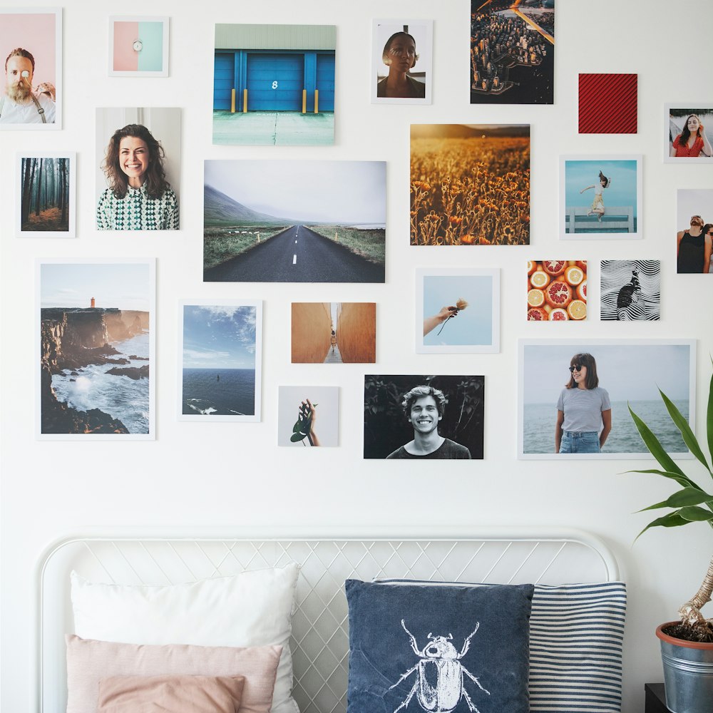 a bed with a bunch of pictures on the wall