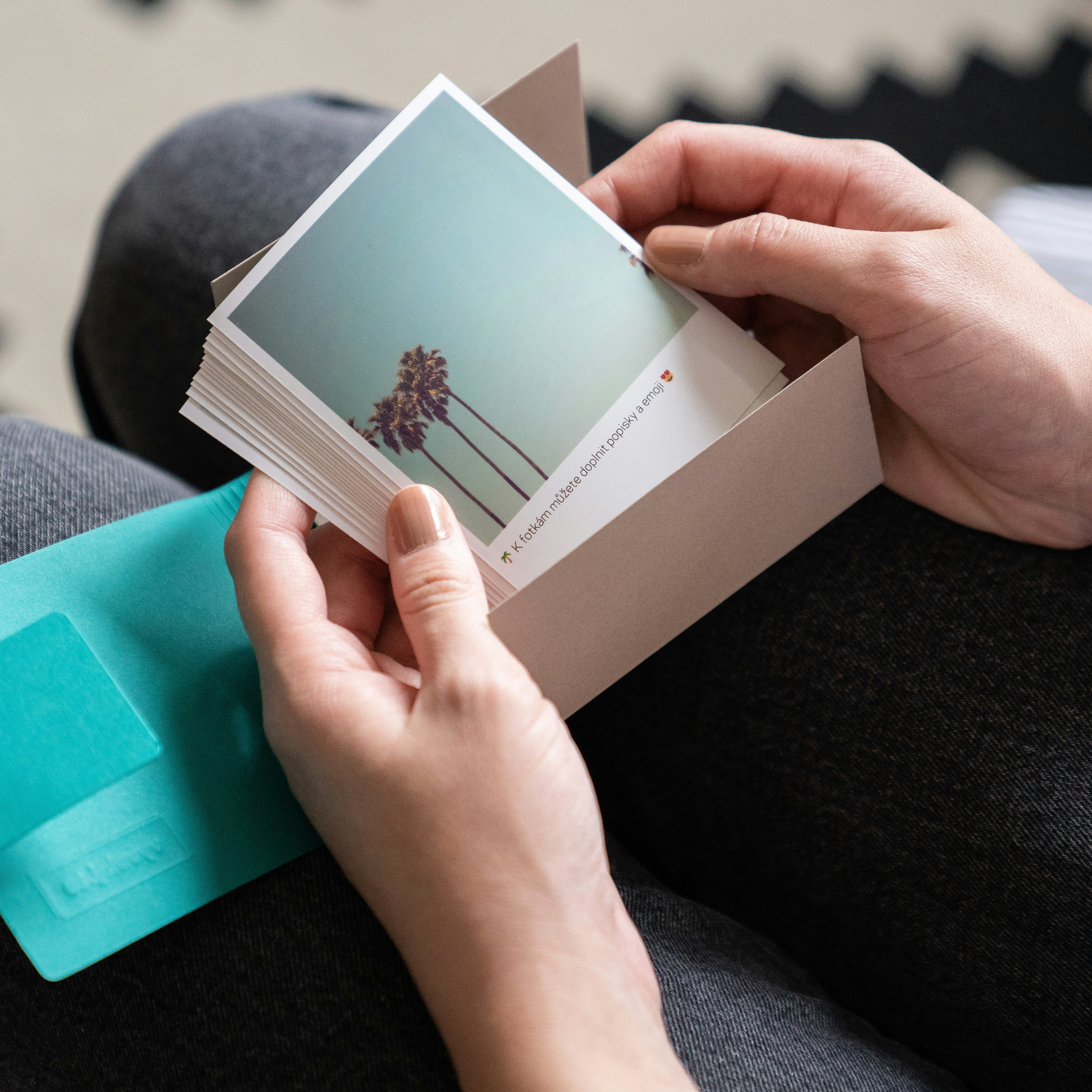 a person holding a card with a palm tree on it