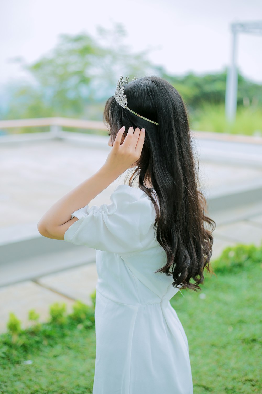 a woman with long hair wearing a white dress