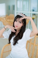 Tiara Parisi lounging on a velvet chaise, bathed in warm, ambient lighting.