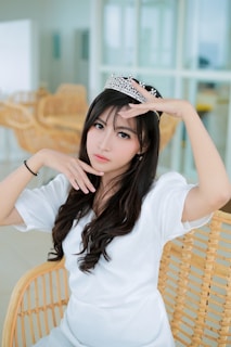 Tiara Parisi lounging on a velvet chaise, bathed in warm, ambient lighting.