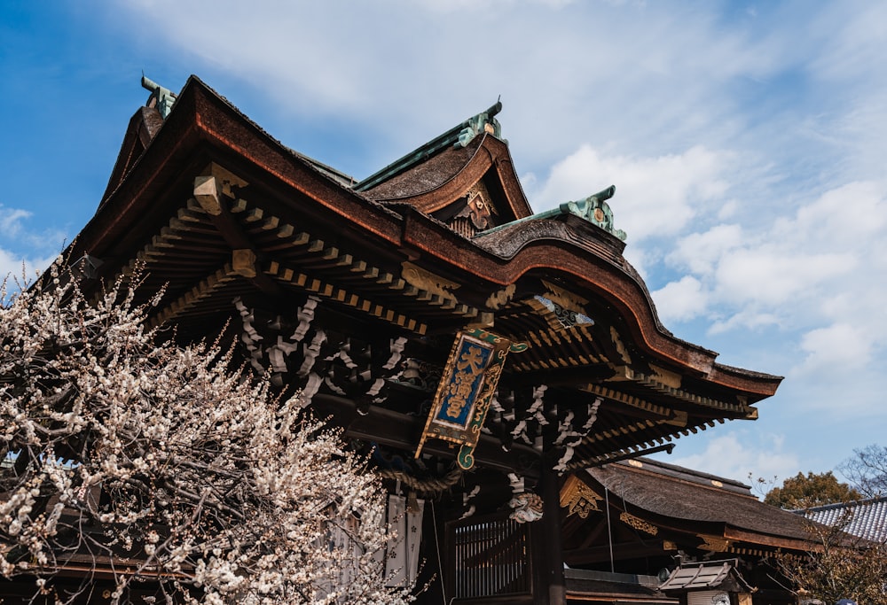 a tall wooden building sitting next to a tree