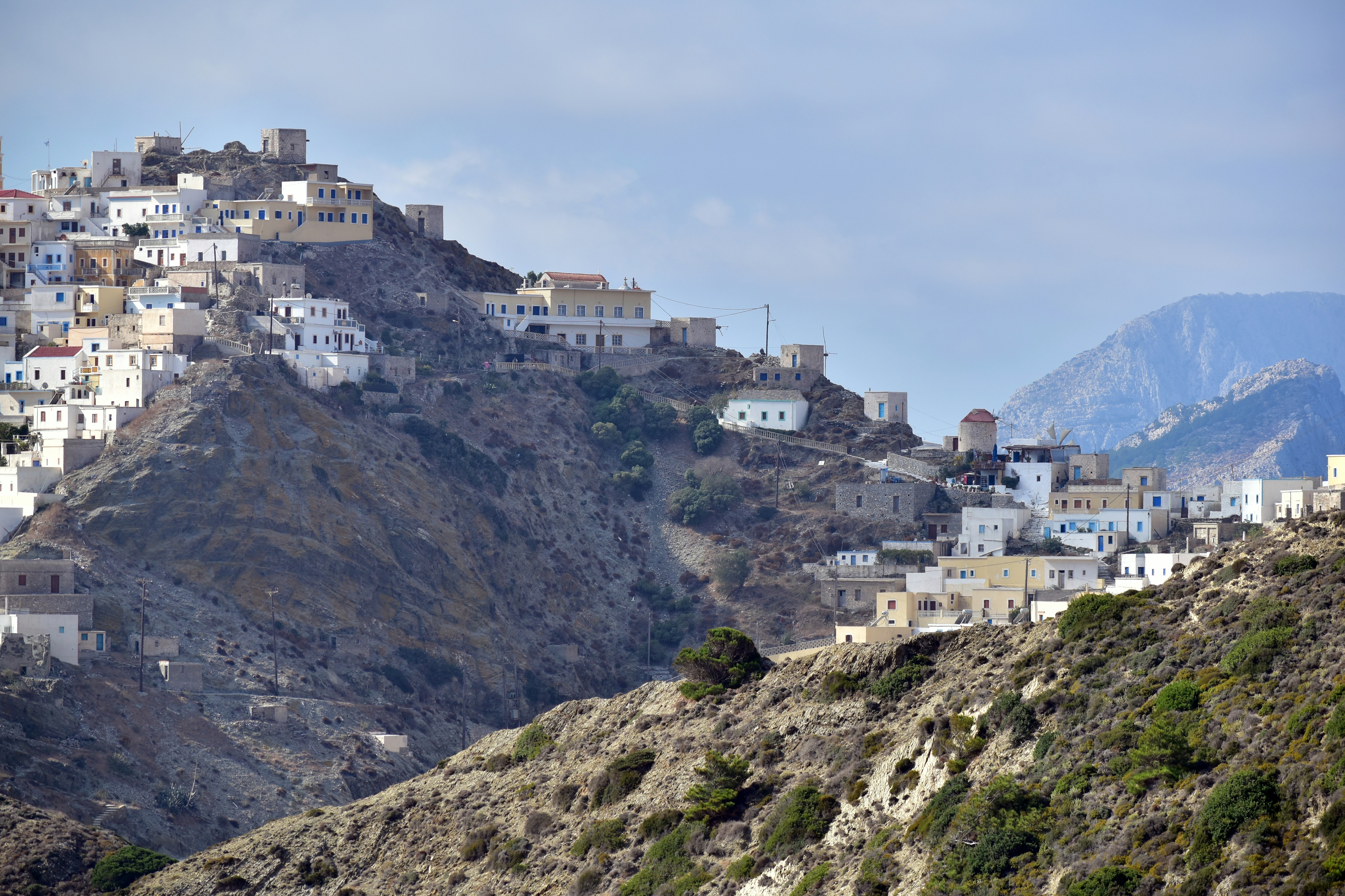 a city on a hill with a mountain in the background