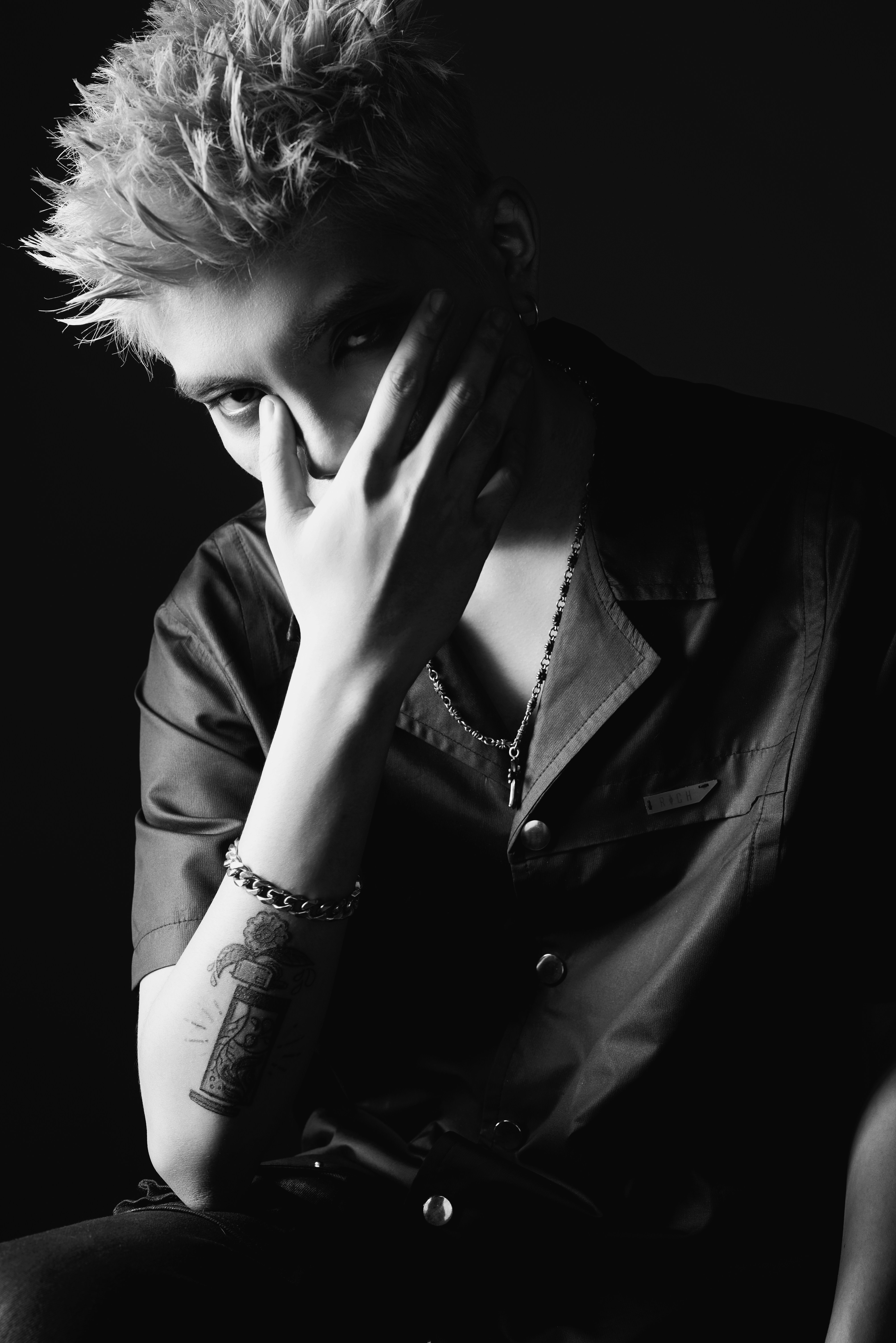 a person sitting down with their hands on their face