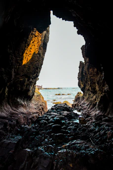 a view of the ocean from inside a cave