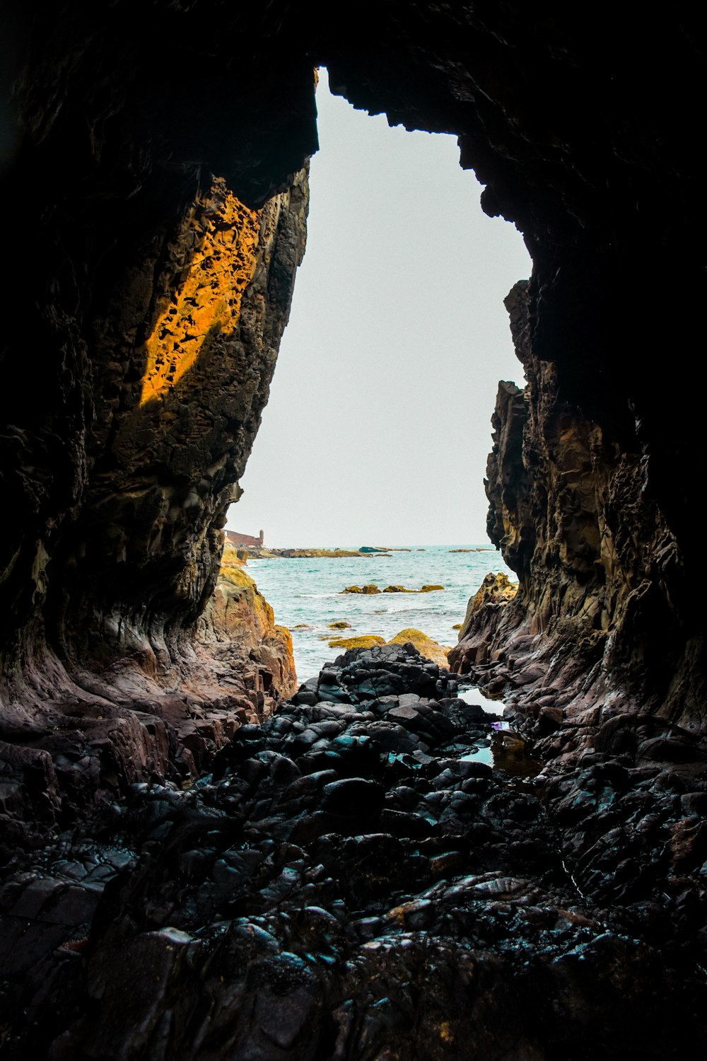 a view of the ocean from inside a cave