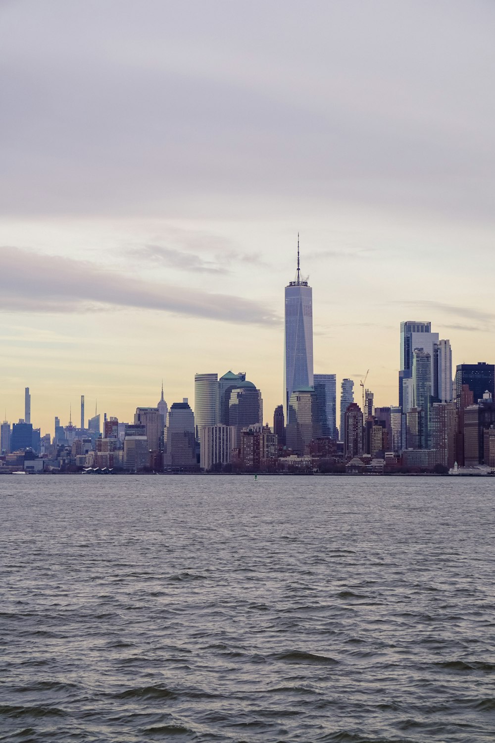 a large body of water with a city in the background