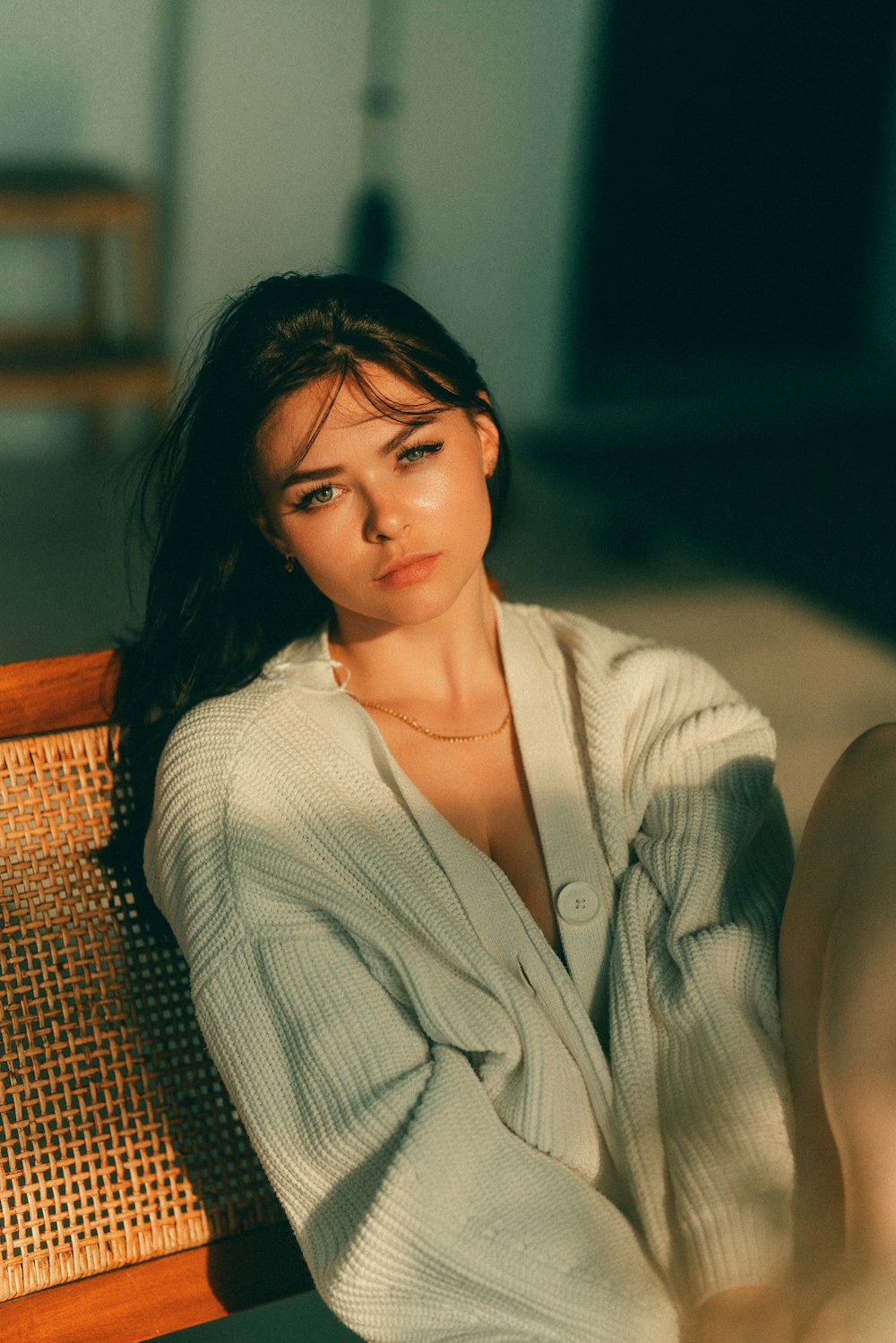 a woman sitting on a wooden bench in a room