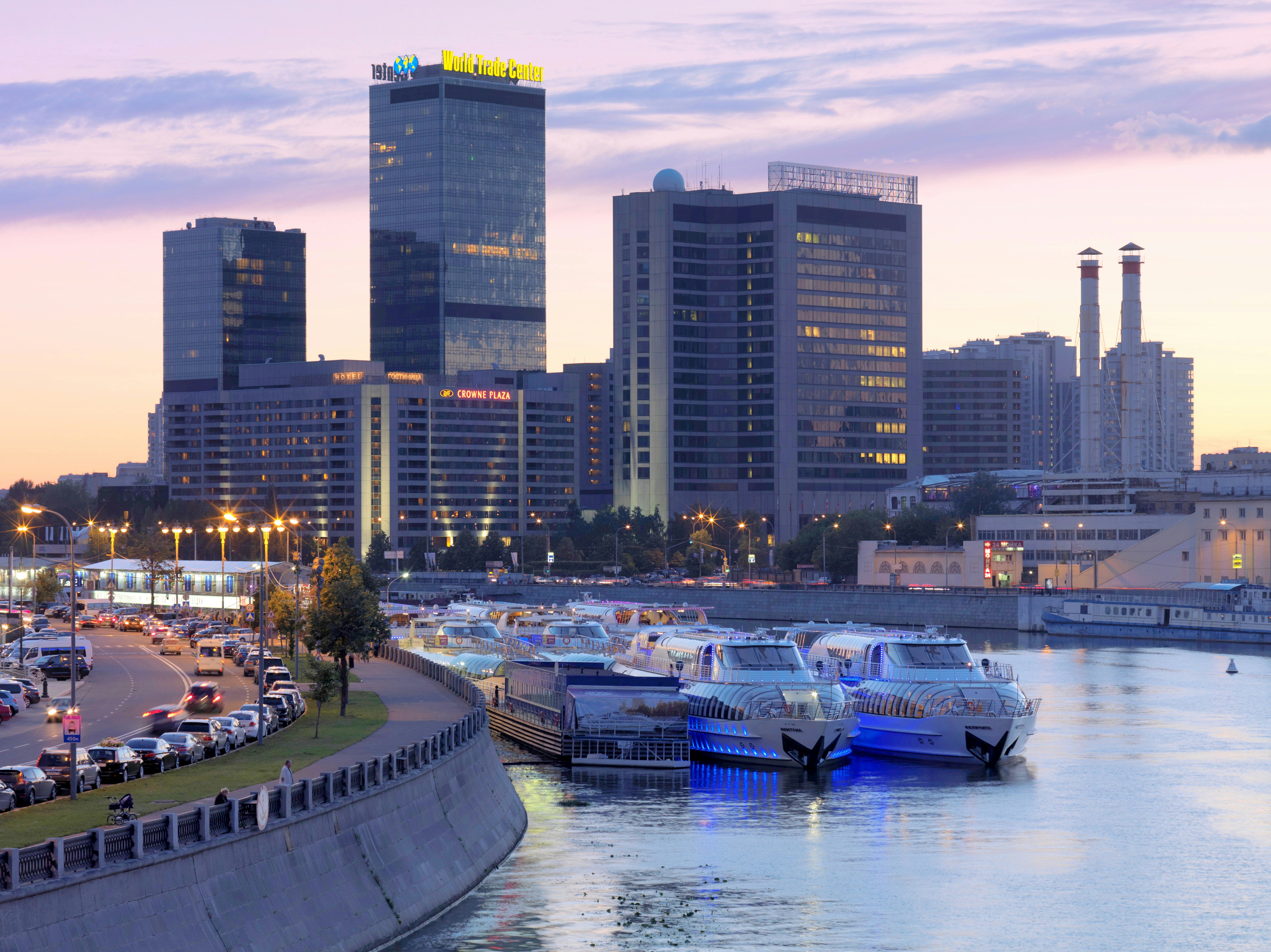 a city with a lot of tall buildings next to a body of water