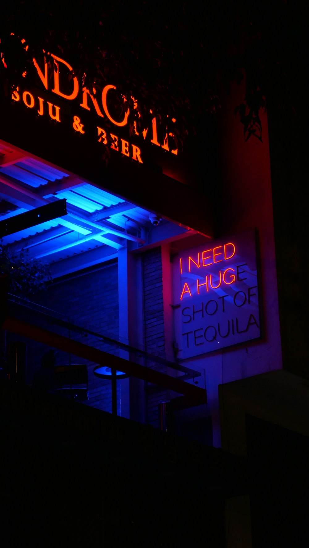 a neon sign is lit up in the dark