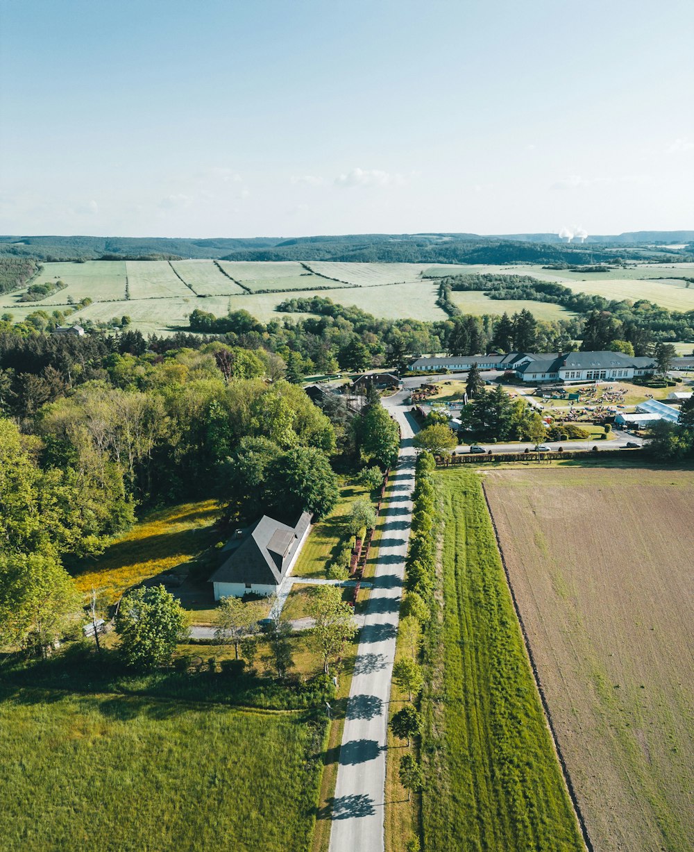 an aerial view of a farm and road