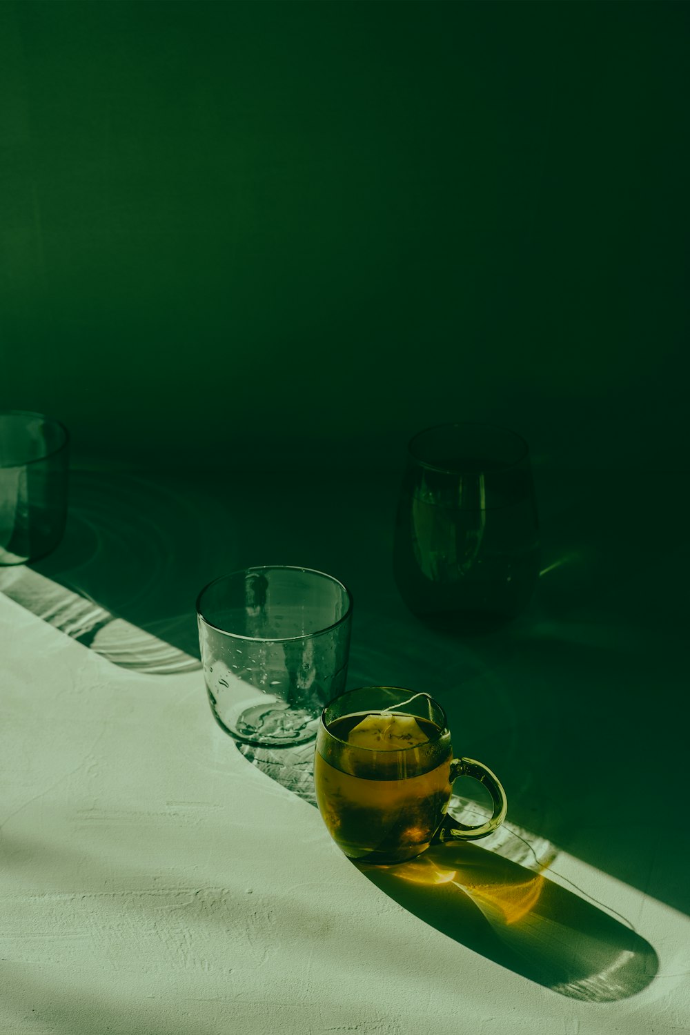 a bottle of oil and a glass on a table