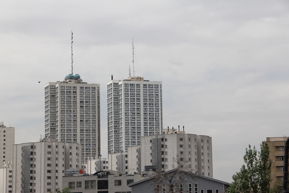 a couple of tall buildings sitting next to each other