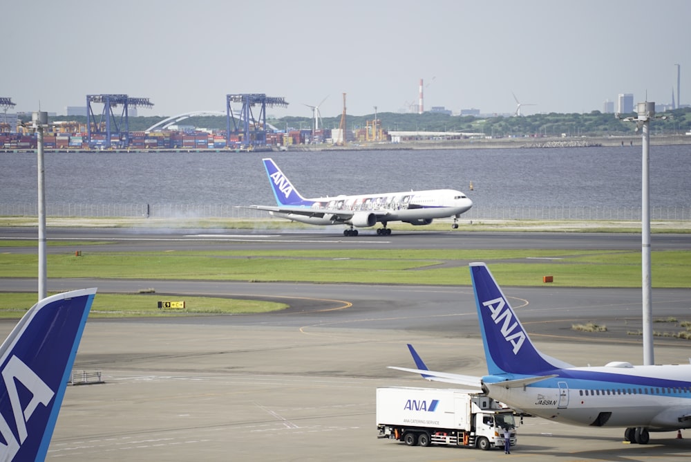 a couple of airplanes that are on a runway