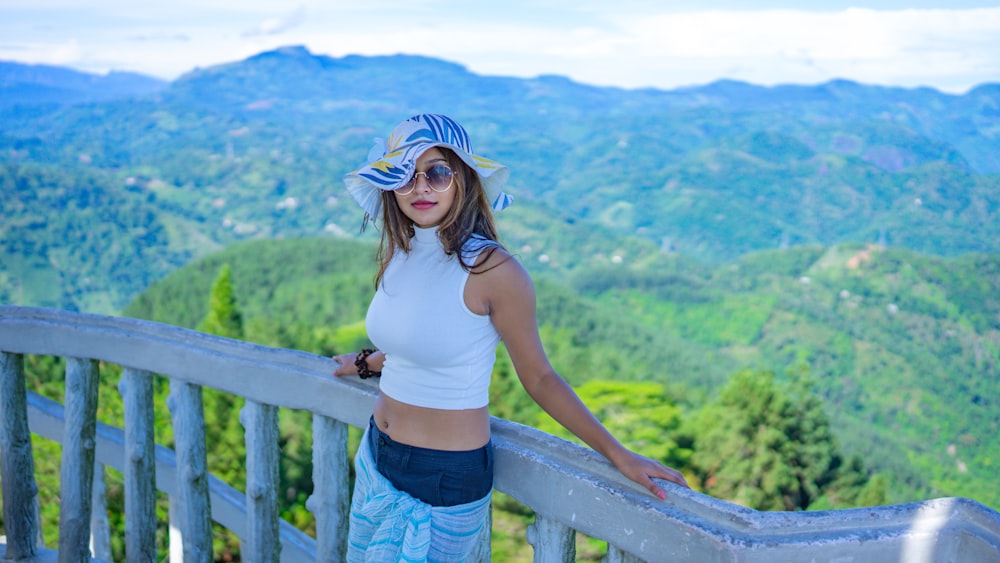 a woman standing on top of a wooden balcony